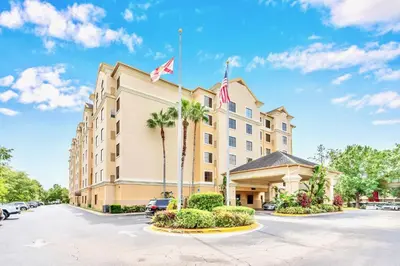 a hotel with a flag on top of it at Apartment w Hot Tub Pool - Near Universal Studios in Orlando