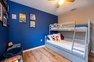 a bedroom with blue walls and bunk beds at Natural Reserve Home at Emerald Islands in Kissimmee