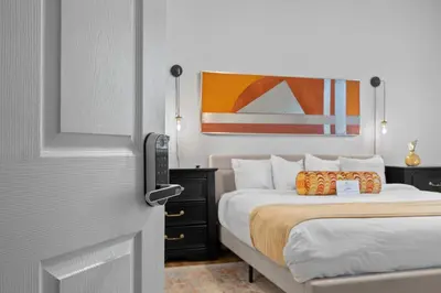 a hotel room with a bed and a door with at Banana Leaf Villa-Vintage Vibes- King Suite in Orlando