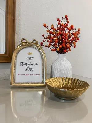 a sign next to a vase and a bowl on a table at Luxury 5BR Villa, Pool Spa, 15min Disney in Orlando