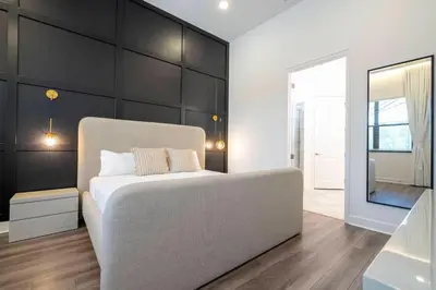 a bedroom with a bed and a black wall at Amazing New 15-bed home up to 30 people in Orlando