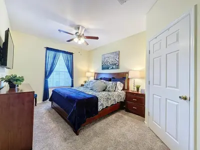 a bedroom with a bed and a ceiling fan at Summer Dreams 3 Bed Condo in Windsor Hills condo in Orlando