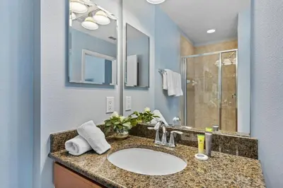 a bathroom with a sink and a mirror at 8965 Cozy home Private Pool in Kissimmee