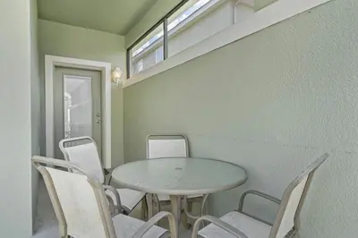 a dining room with a table and chairs at 8965 Cozy home Private Pool in Kissimmee