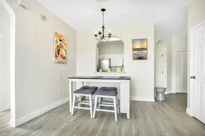 a kitchen with a table and two stools at 8102-IBRAHIM · 8102 Vacation getaway at Windsor in Kissimmee