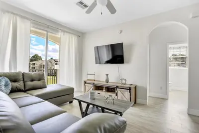 a living room with a couch and a table at 8102-IBRAHIM · 8102 Vacation getaway at Windsor in Kissimmee