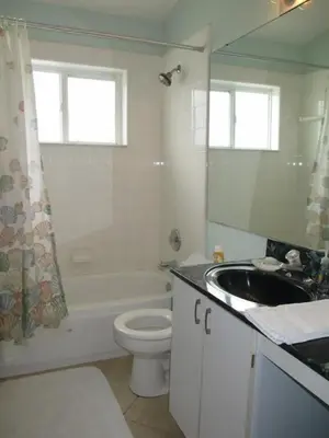 a bathroom with a white toilet and a sink at Family Fun Vacation Home villa in Kissimmee