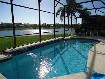 a swimming pool with a view of the water at Lake House near Disney in Kissimmee