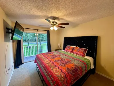 a bedroom with a bed and a ceiling fan at Grand Deluxe 3BR Townhouse near Disney Parks in Kissimmee