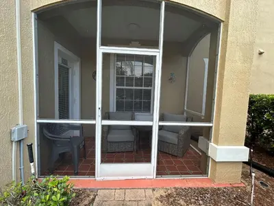 an open door of a house with a patio at Disney Fan Condo-Renovated 2024 in Kissimmee