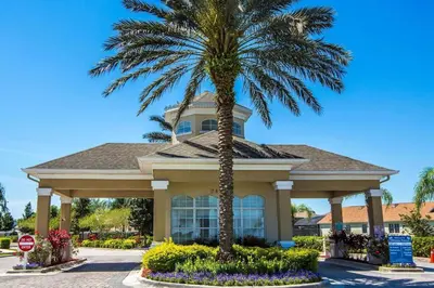 a palm tree in front of a house with a stop sign at Disney Fan Condo-Renovated 2024 in Kissimmee