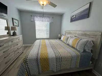 a bedroom with a bed and a ceiling fan at Disney Fan Condo-Renovated 2024 in Kissimmee
