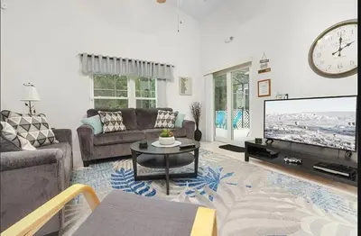 a living room with a couch and a tv at Tropical Escape By Shine Villas 244 in Kissimmee