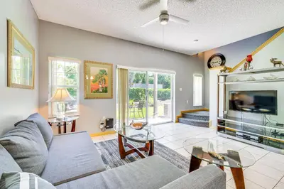 a living room with a couch and a tv at 5 Mi to Disney Family-Friendly Kissimmee Retreat! in Kissimmee