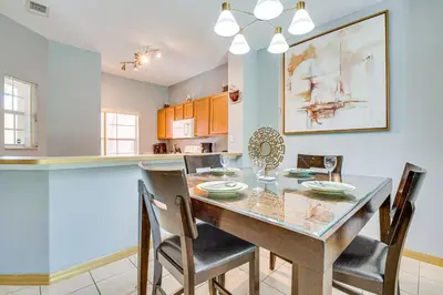 a dining room and kitchen with a table and chairs at 5 Mi to Disney Family-Friendly Kissimmee Retreat! in Kissimmee