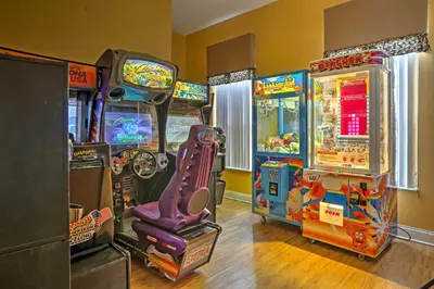 a group of arcade games in a room at 5 Mi to Disney Family-Friendly Kissimmee Retreat! in Kissimmee