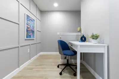a office with a blue chair and a desk at Beautiful Townhome with Splash Pool near Disney 31 in Kissimmee