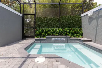 a swimming pool in the middle of a house at Beautiful Townhome with Splash Pool near Disney 31 in Kissimmee