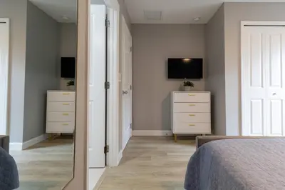 a bedroom with a bed and a tv on a wall at Beautiful Townhome with Splash Pool near Disney 31 in Kissimmee