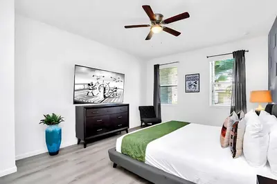 a white bedroom with a bed and a ceiling fan at Upstay-Mansion w Spa-Pool-Cinema-Games - Sleeps 36 in Kissimmee