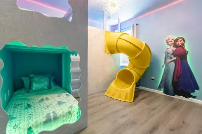 a room with a disney bedroom with a bed and a window at Upstay-Mansion w Spa-Pool-Cinema-Games - Sleeps 36 in Kissimmee
