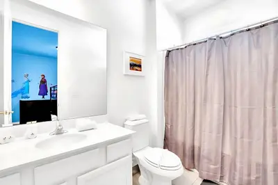 a white bathroom with a sink and a toilet at Upstay-Mansion w Spa-Pool-Cinema-Games - Sleeps 36 in Kissimmee