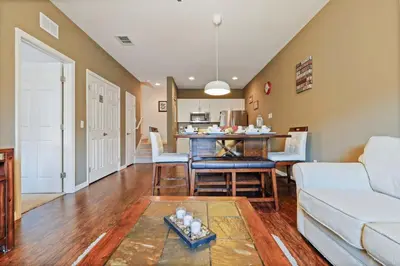 a living room with a couch and a table at Family Spacious 3BR Townhouse with BBQ n' Pool Access in Kissimmee