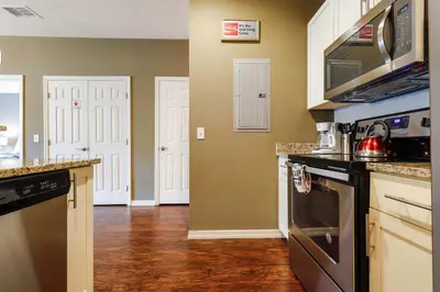 a kitchen with a sink and a stove top oven at Family Spacious 3BR Townhouse with BBQ n' Pool Access in Kissimmee