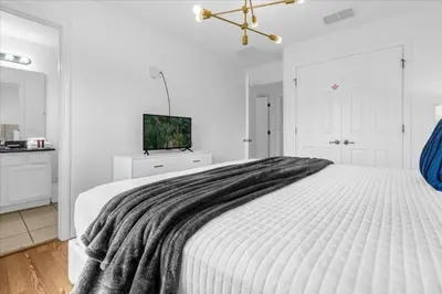 a white bedroom with a large white bed with a blanket at 3 Bed 2,5 Bath Perfect Family home Bunk Beds townhouse in Kissimmee