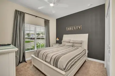a bedroom with a large bed and a window at 3097Pequod townhouse in Kissimmee