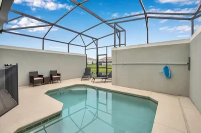 a swimming pool with a large glass roof at 3097Pequod townhouse in Kissimmee