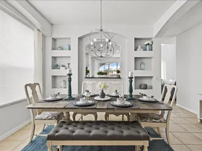 a dining room with a table with chairs and a chandelier at Treasure Hunt Retreat home in Kissimmee