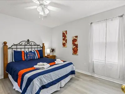 a bedroom with a bed and a ceiling fan at Treasure Hunt Retreat home in Kissimmee