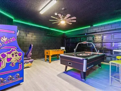 a gaming room with a ping pong table and a game system at Treasure Hunt Retreat home in Kissimmee