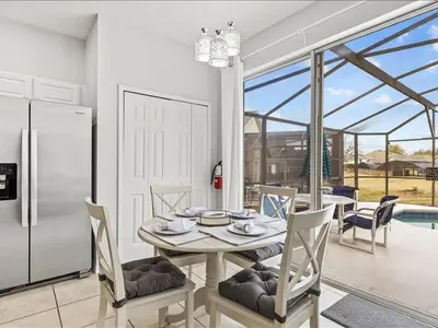 a kitchen and dining room with a table and chairs at Treasure Hunt Retreat home in Kissimmee