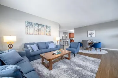 a living room with a blue couch and a table at Vista Cay Luxury Rhapsody condo in Orlando
