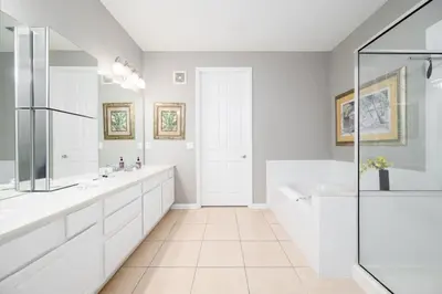 a white bathroom with a tub and a shower at Vista Cay Luxury Rhapsody condo in Orlando