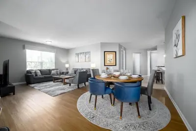 a dining room and living room with a table and chairs at Vista Cay Luxury Rhapsody condo in Orlando