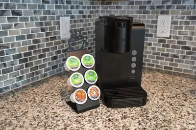 a black coffee maker with stickers on a counter at Storey Lake Pool Home with Resort Amenities near DISNEY in Kissimmee