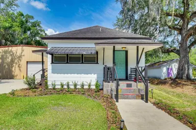a white house with a green door and a sidewalk at Walk to Historic Dtwn Sanford Home with Gas Grill! in Sanford