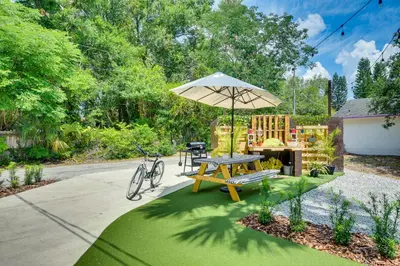 a patio with a picnic table and an umbrella at Walk to Historic Dtwn Sanford Home with Gas Grill! in Sanford