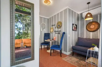 a living room with a blue couch and a table at Spring-Fed Lake King Suite Pet Friendly in Orlando