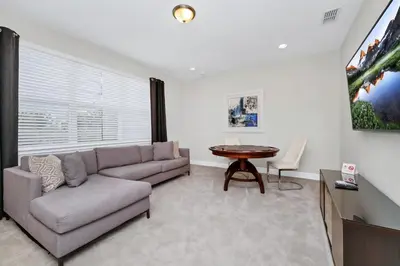 a living room with a couch and a table at Marvelous Home With Private Pool And Waterpark Access Near Disney At Encore Resorts Reunion - 131La in Kissimmee
