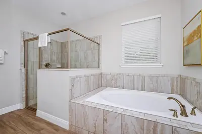 a white bathroom with a tub and a window at Marvelous Home With Private Pool And Waterpark Access Near Disney At Encore Resorts Reunion - 131La in Kissimmee