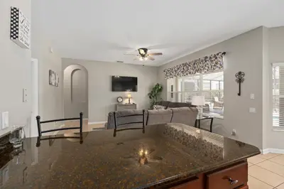 a living room with a couch and a table at Modern Luxury 6 Bed Pool Home Close To Disney in Orlando