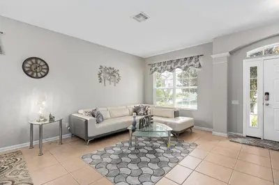 a living room with a couch and a table at Modern Luxury 6 Bed Pool Home Close To Disney in Orlando