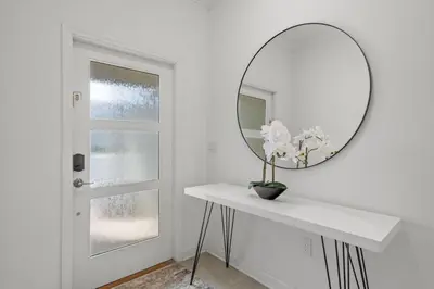 a white room with a mirror and a white table at Modern design near Disney Top resort in Kissimmee