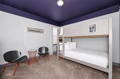 a bedroom with a bed and two chairs at Spacious Home Near Disney With Game And Themed Rooms With Waterpark & Resort Access At Encore Resorts Reunion - 581La in Kissimmee