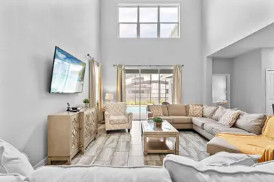 a living room with a couch and a table at 5 Bedroom 5 Bathroom Storey Lake 4760KC in Kissimmee