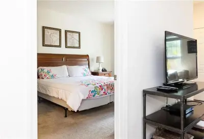 a bedroom with a bed and a television on a table at 3 Bedroom 2 Bathroom Lucaya Village 15-103 in Kissimmee